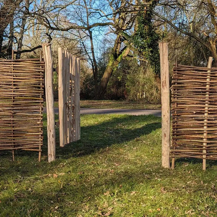 A rustic garden gate with intricate ironwork details.