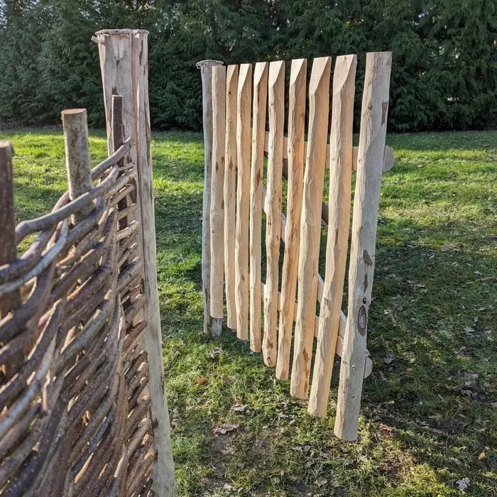 Chestnut gate leading to a whimsical garden path.