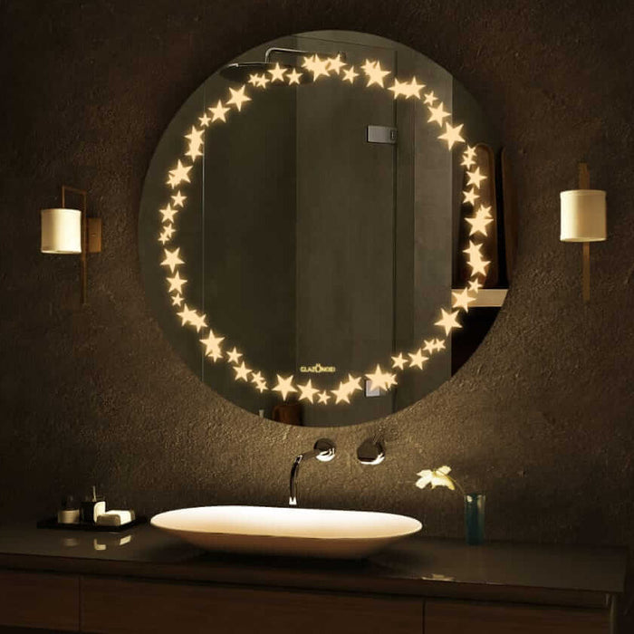 A round bathroom mirror with LED lights around the circumference. The mirror is mounted on a bathroom wall above a sink. There is text written on the bottom right corner of the mirror that says Glazonoid.