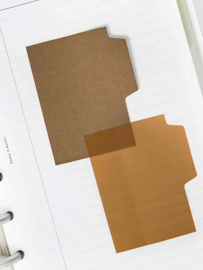 Blank Tab Sticky Note Set, Taos, Cloth and Paper. One matte and one transparent sticky note from the set placed on a task insert. The transparent sticky note is layered over the bottom right corner of the matte sticky note.