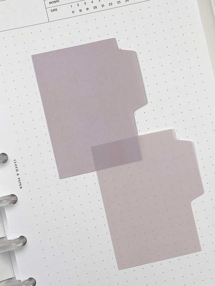 Blank Tab Sticky Note Set, Orchid, Cloth and Paper. One matte and one transparent sticky note from the set placed on a task insert. The transparent sticky note is layered over the bottom right corner of the matte sticky note.