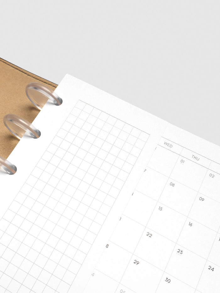 Close up of Half Page Inserts Graph inside discbound planner and leather cover.