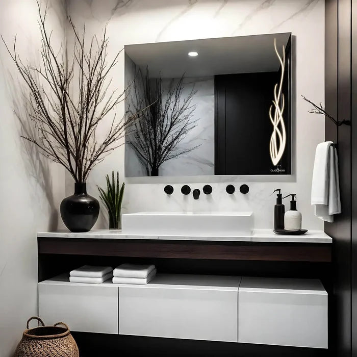 Classic white themed bathroom vanity with a rectangular LED mirror, white ceramic sink, chrome faucet, and a vase filled with pink and white flowers. A towel hanging on the wall, with 2 shampoo bottles kept on the vanity.