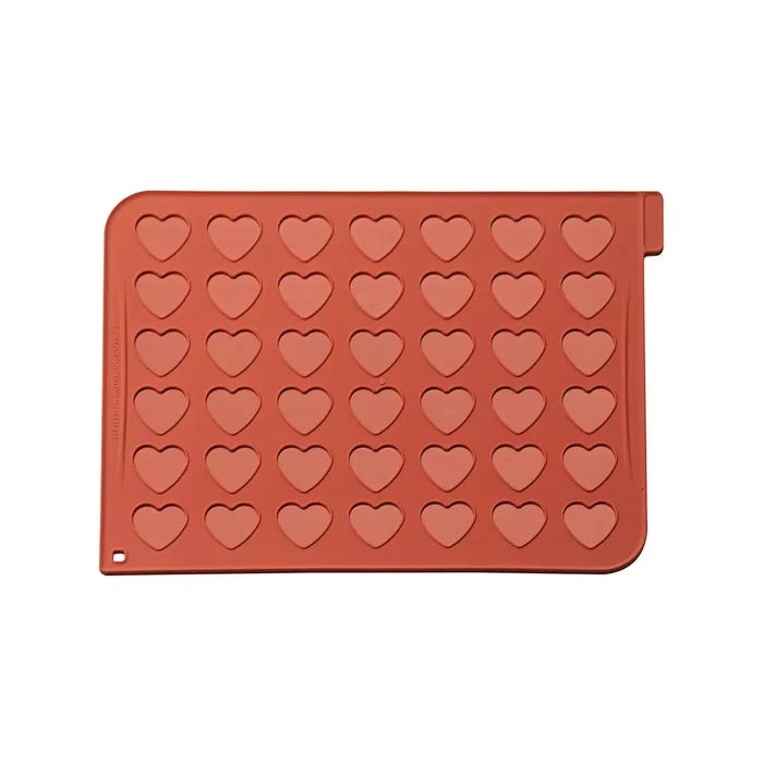 Red silicone mold with heart shapes on a white background