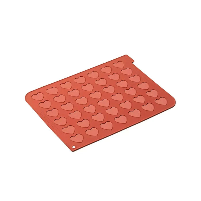 Red silicone mold with heart shapes on a white background