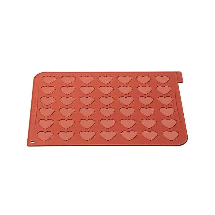 Red silicone mold with heart shapes on a white background
