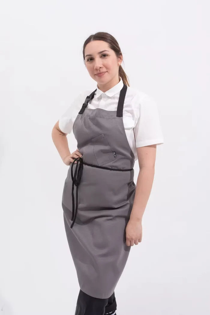 Person wearing a gray apron on a white background