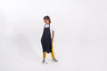 Person wearing a Navy Blue apron and yellow pants on a white background